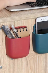 White wall-mounted phone holder with cable entry shown close-up