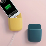 Wall phone holder mounted above a desk holding smartphone and remote