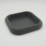 White rounded key tray on entryway console holding keys and coins