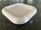 Rounded key tray in white with soft curves, close-up detail