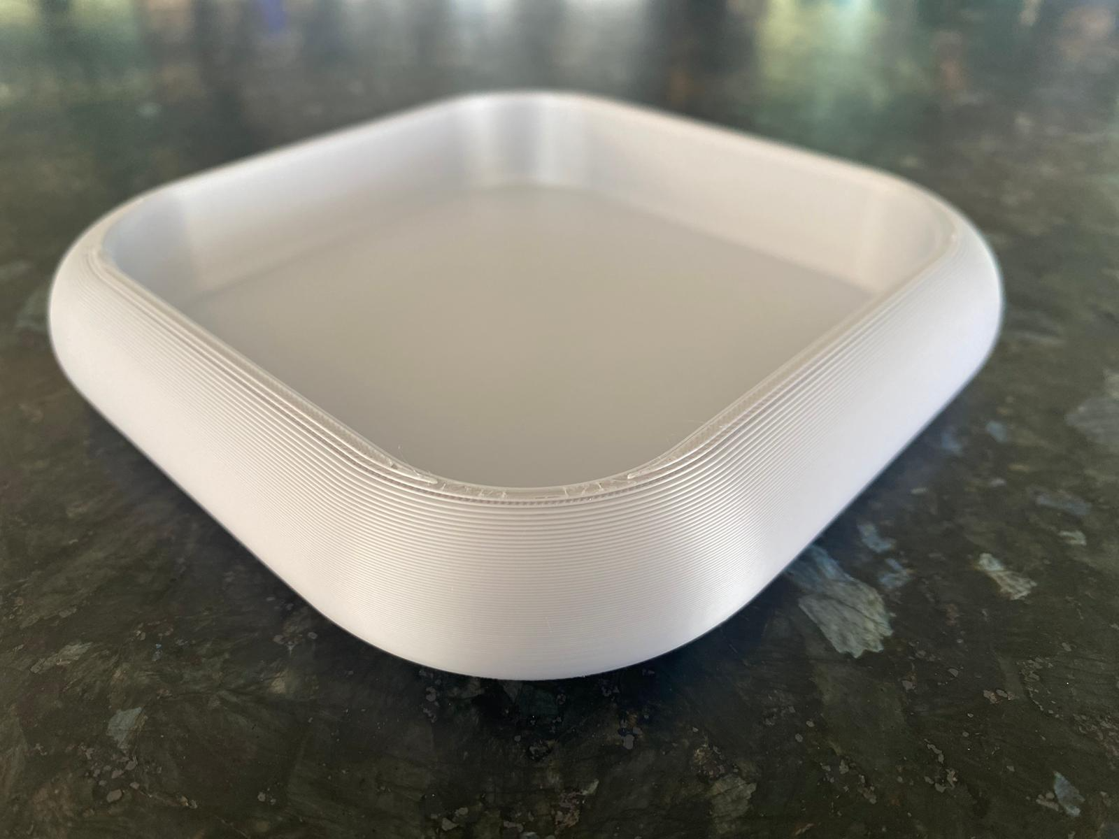 Rounded key tray in white with soft curves, close-up detail