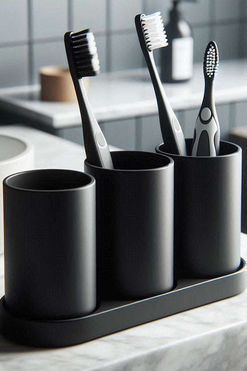 Close-up of white toothbrush holder set with three cylindrical cups and coaster