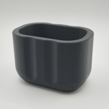 Modern sponge holder displayed on a kitchen counter next to a white sink