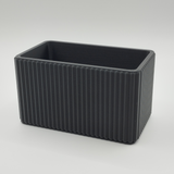 Ribbed organizer styled on desk with pens and office essentials inside