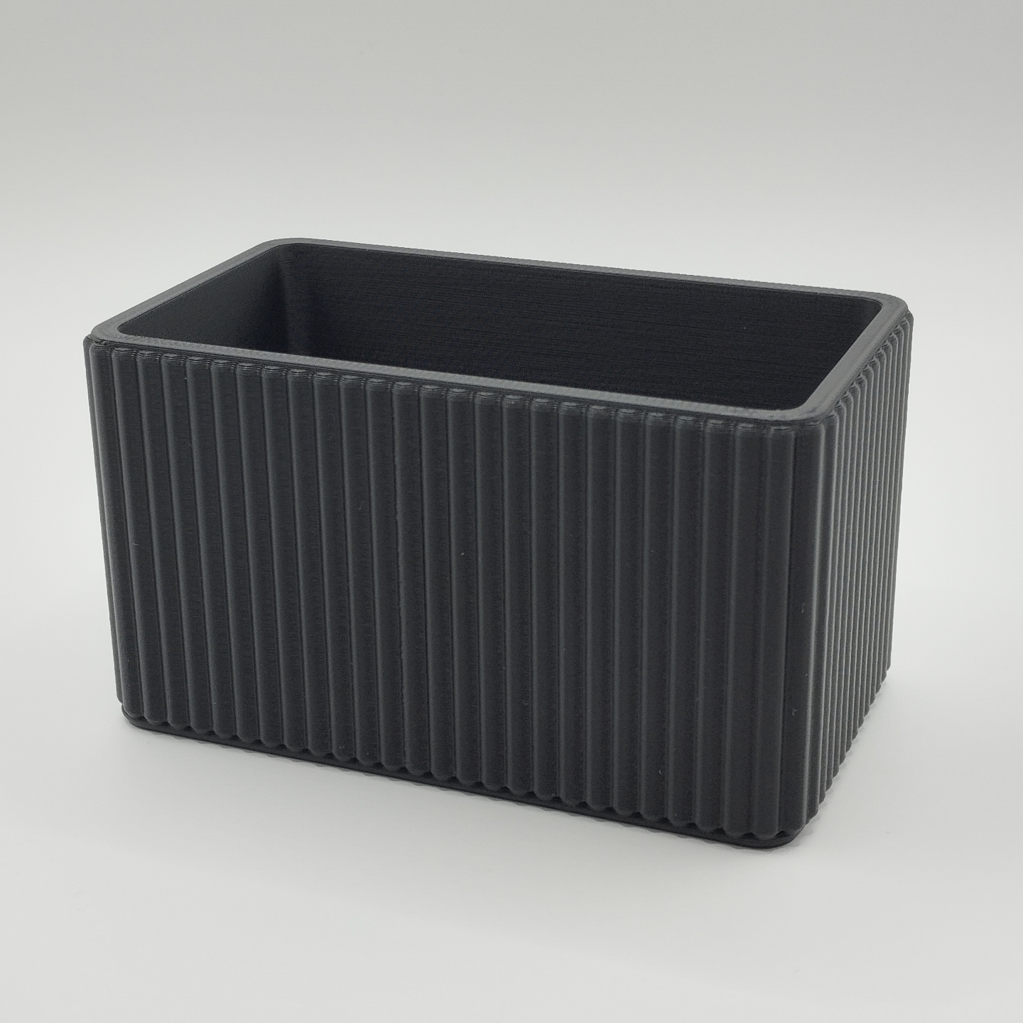 Ribbed organizer styled on desk with pens and office essentials inside
