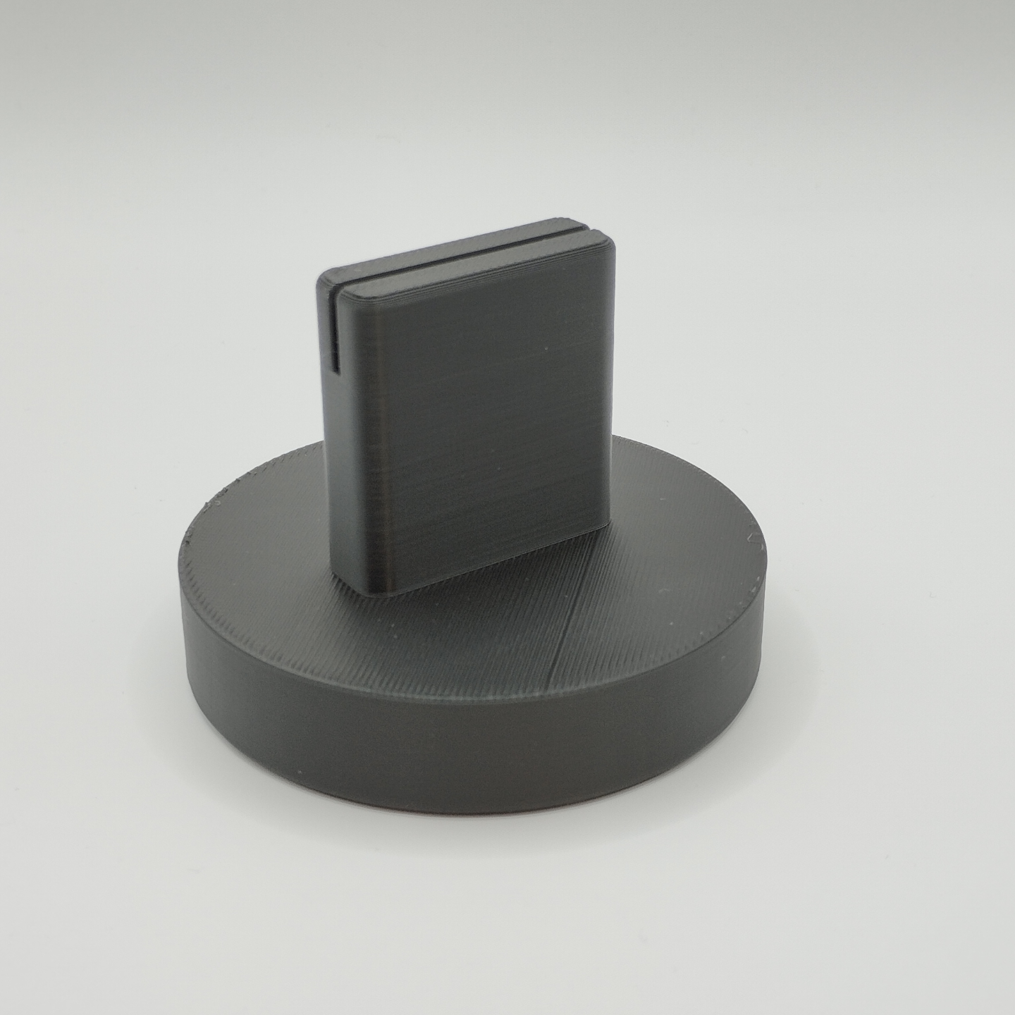 Minimalist picture stand on a wooden desk next to a potted plant