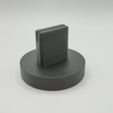 Minimalist picture stand on a wooden desk next to a potted plant