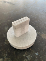 Geometric card holder displaying a small white postcard
