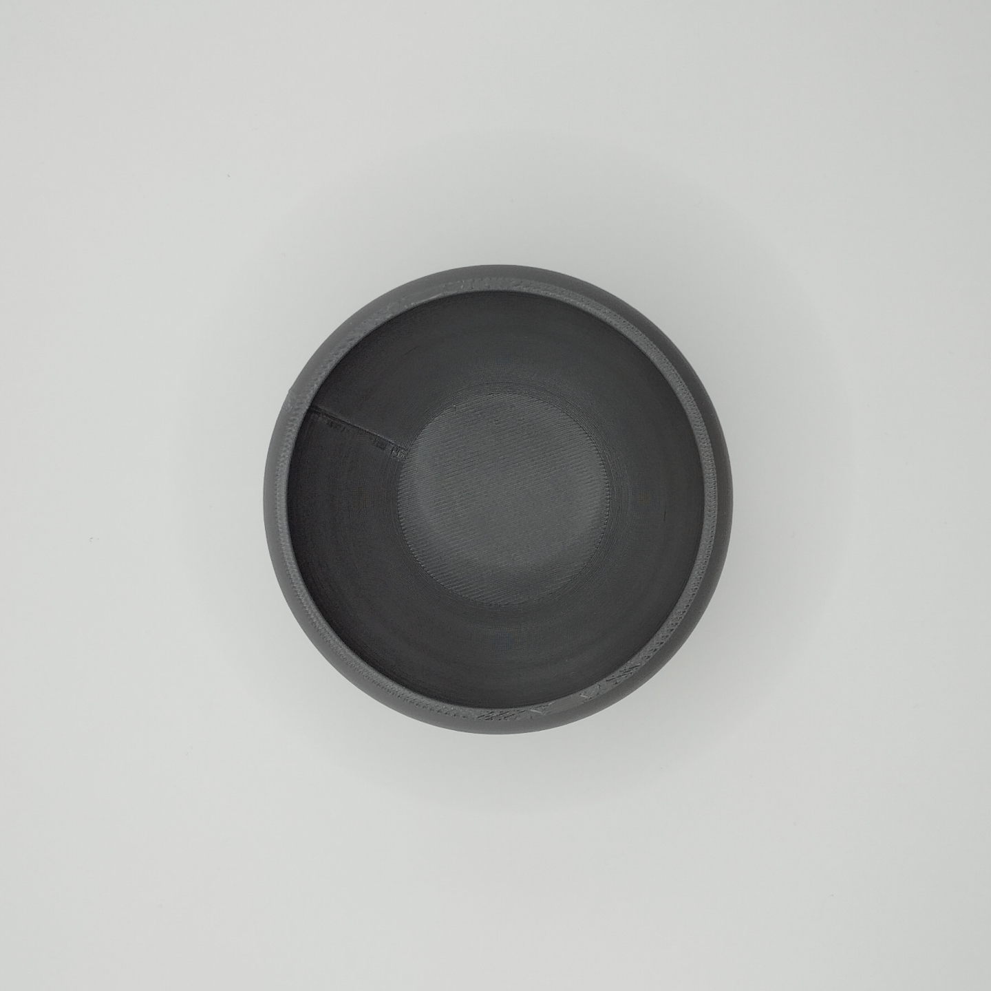 Close detail of the refined rim and smooth surface of the ceramic-like bowl