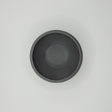 Close detail of the refined rim and smooth surface of the ceramic-like bowl