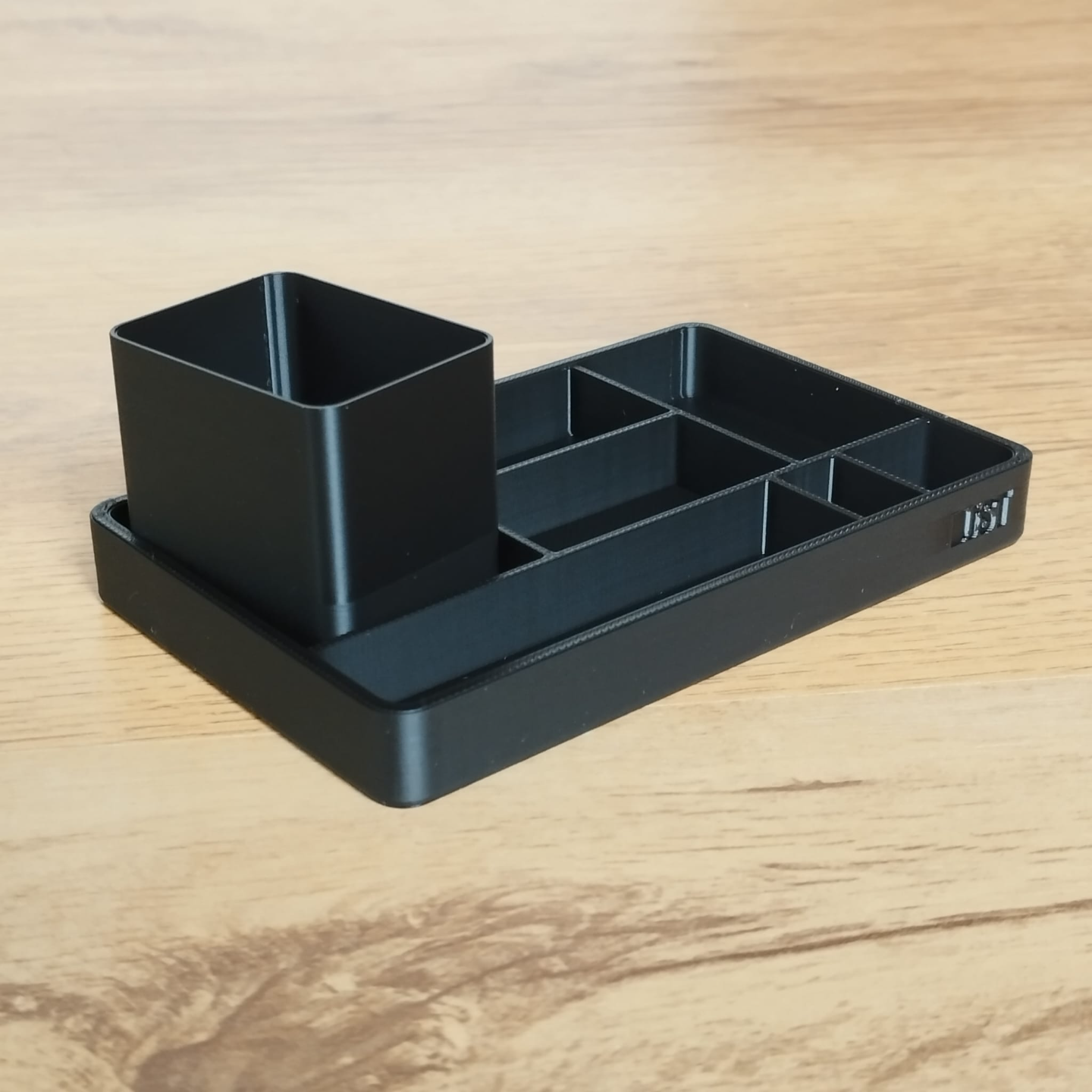 Close-up of minimalist office organizer tray and pencil cup with clean lines