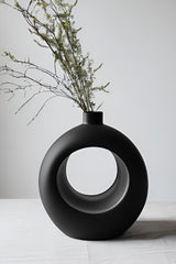 Close-up of minimalist ring vase showing smooth geometric form and circular opening