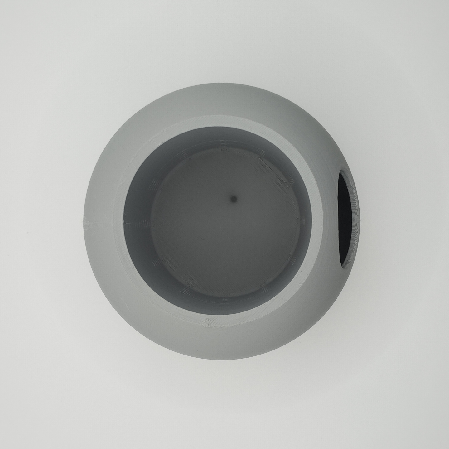 Close-up of self-watering chamber system showing water-level detail on plant pot