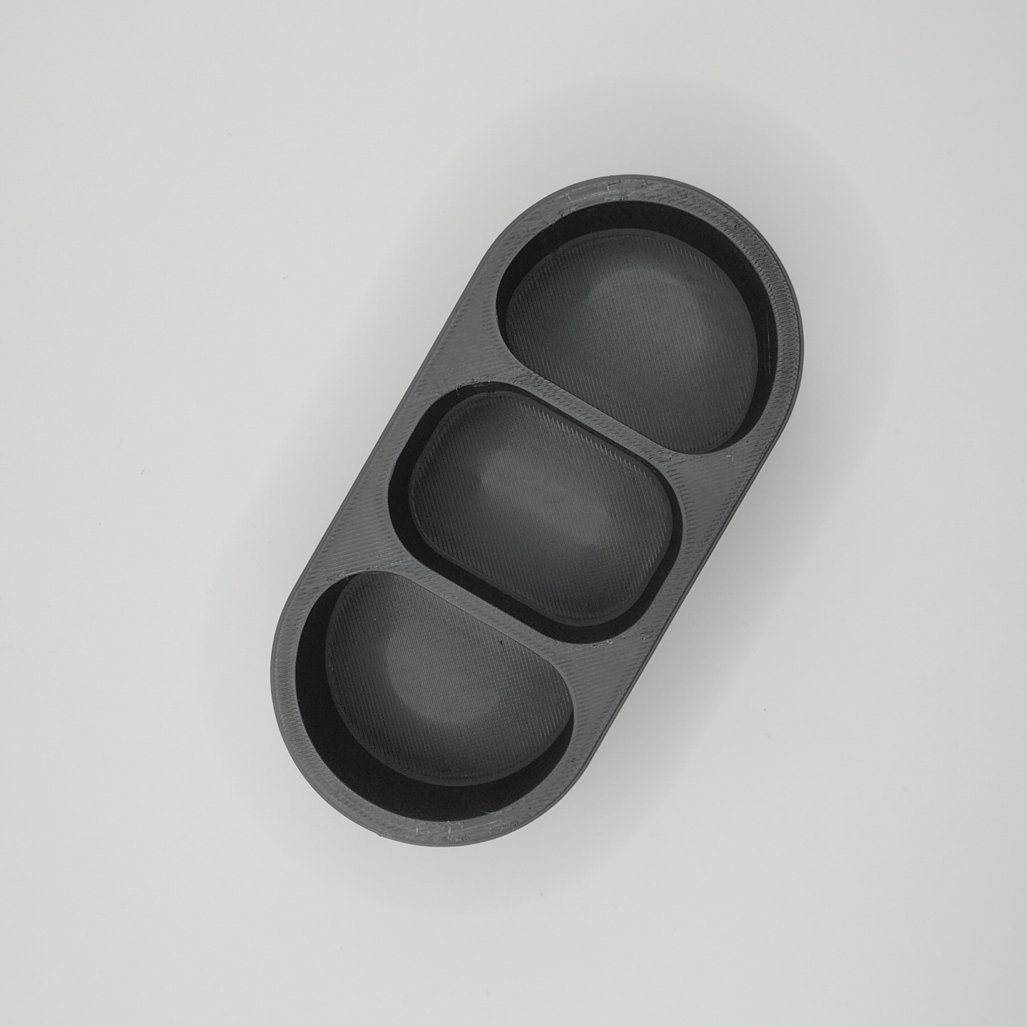 Detail of smooth curved surface and soft contours on rounded remote holder
