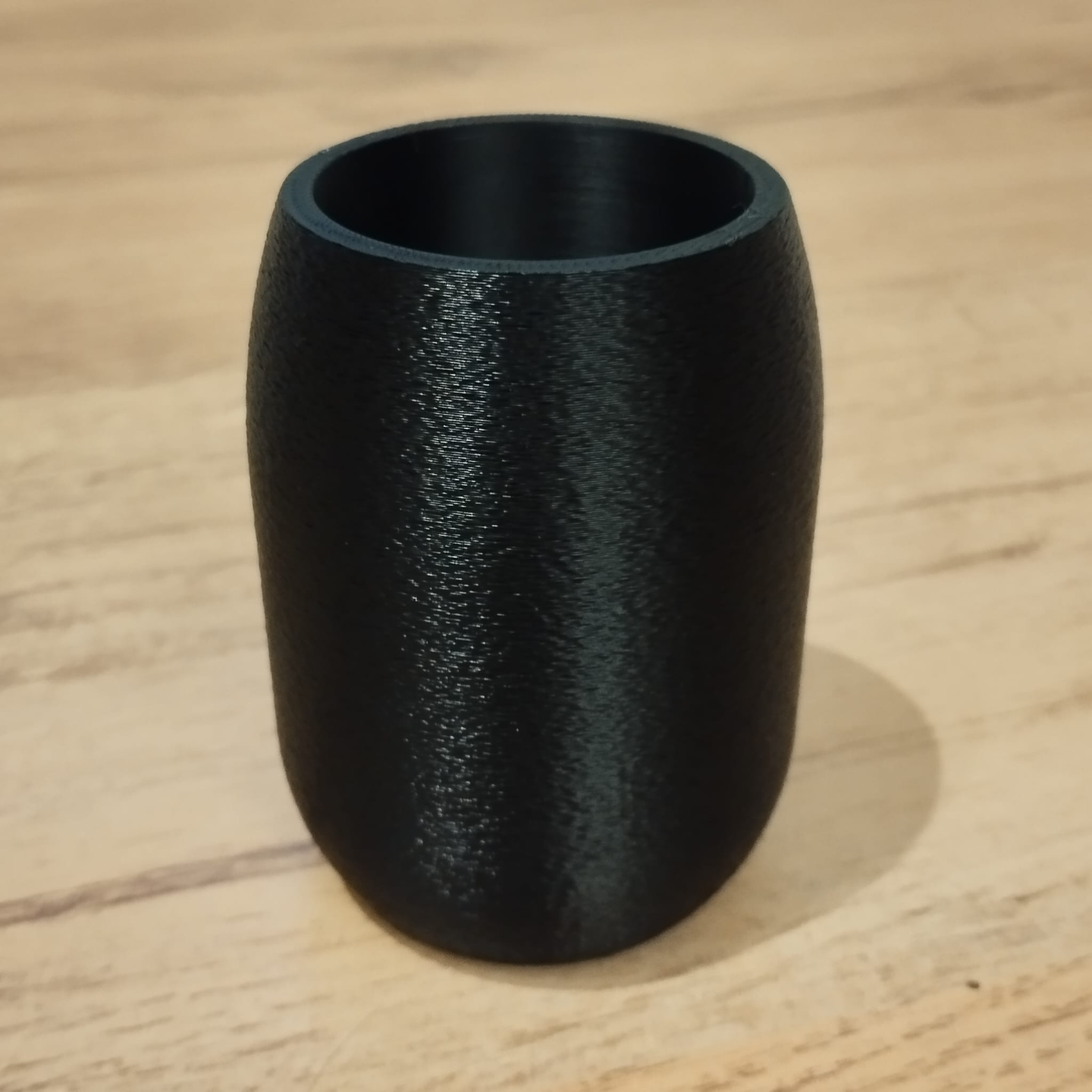 Close-up of textured round pencil holder showing organic surface detail