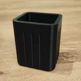 Close-up of minimalist square pencil holder with textured grooved sides