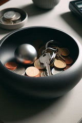 Modern key and coin catch bowl in white, top view showing smooth interior