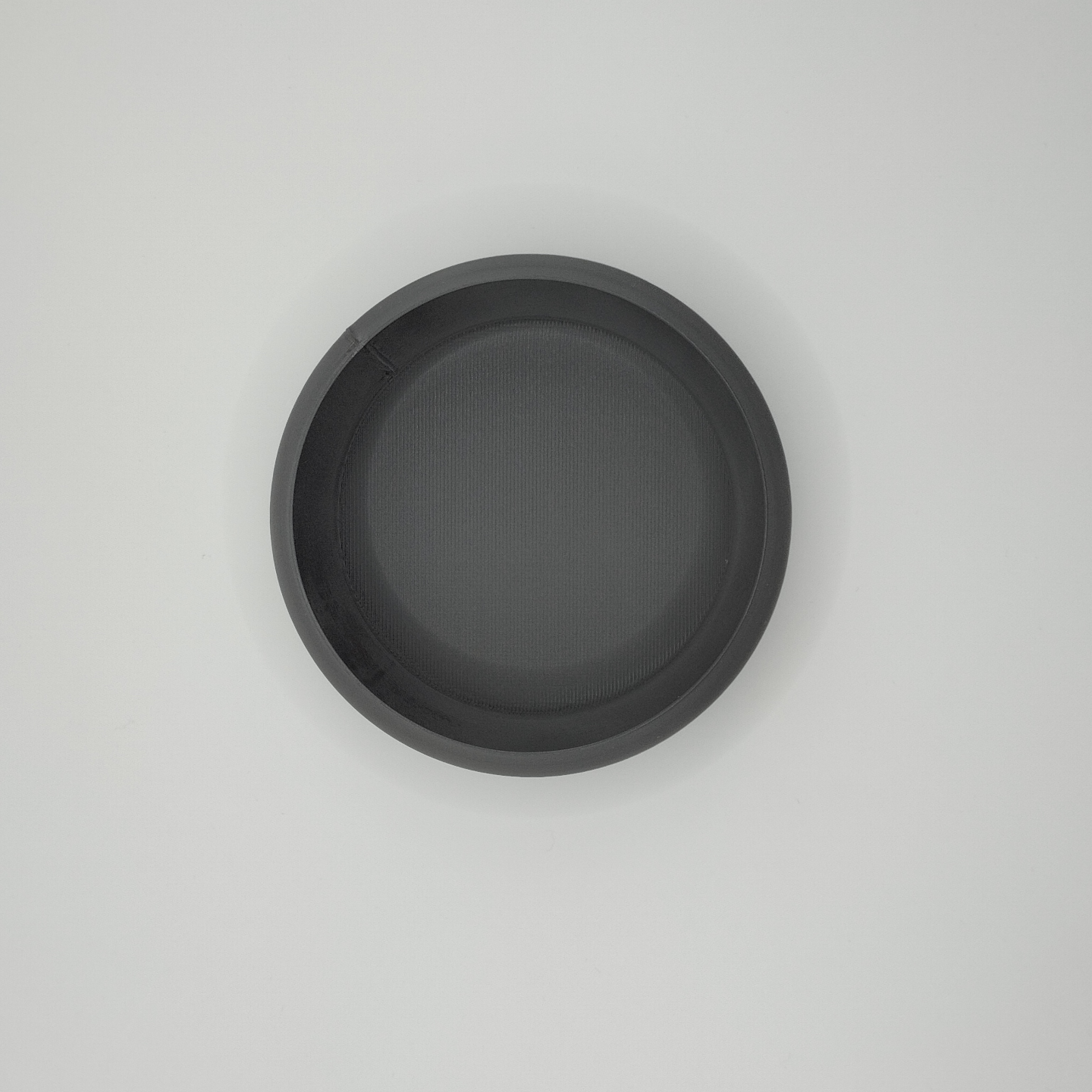Close-up detail of key and coin bowl's clean edge and subtle surface texture