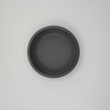 Close-up detail of key and coin bowl's clean edge and subtle surface texture