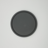 Close detail of the coaster's flat, refined surface texture