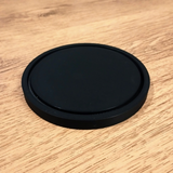 Smooth round minimalist coaster viewed from above, clean geometry and matte surface