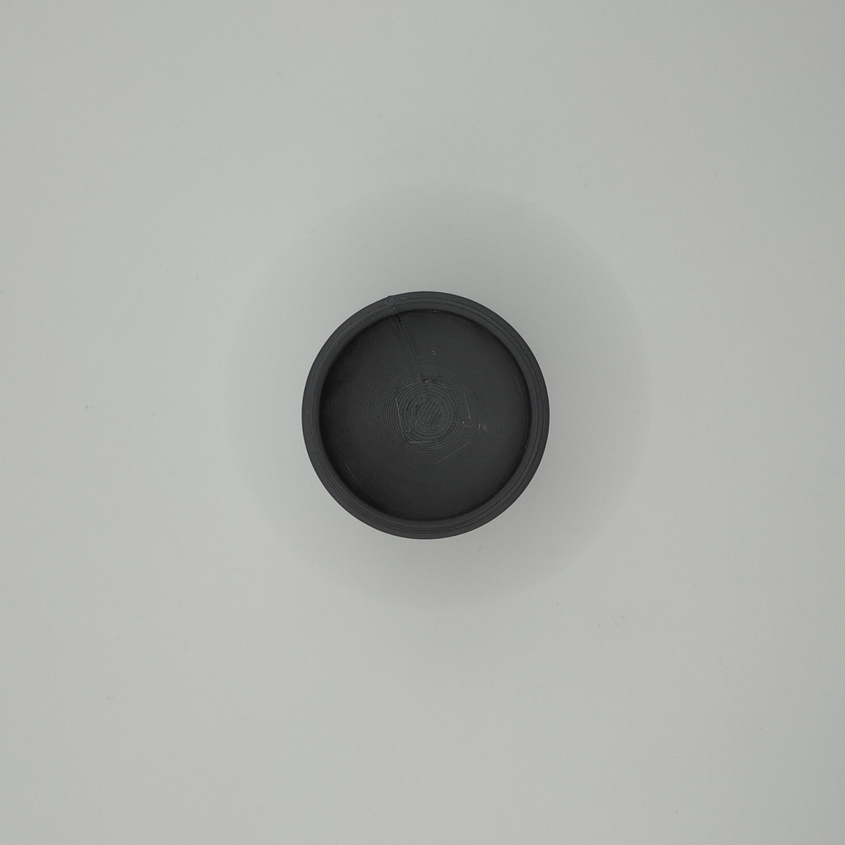 Close-up of a matte white minimalist egg cup showing clean cone form