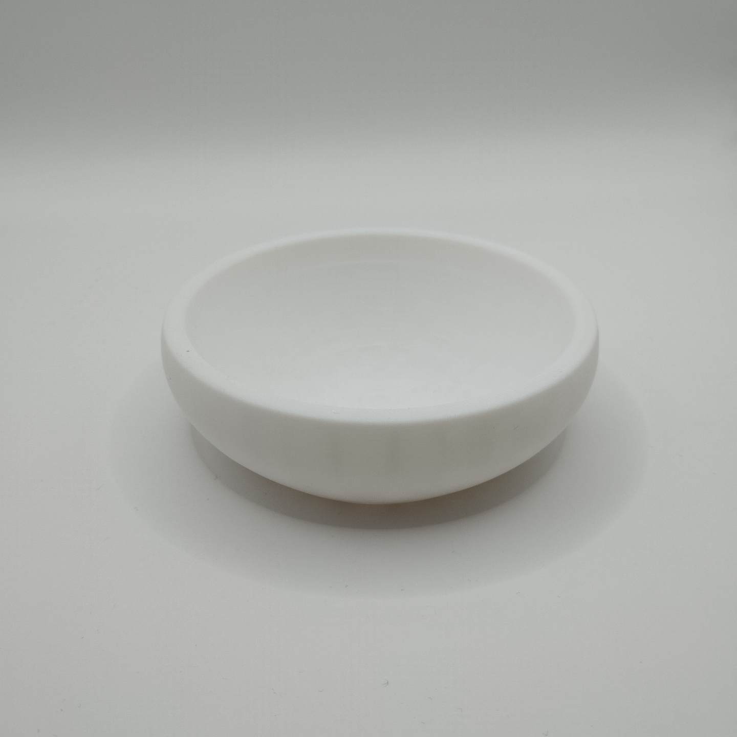 Minimalist key and coin catcher bowl styled on entryway table with scattered keys