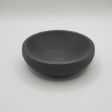 Detail of the flat bowl's smooth interior surface and clean edge profile