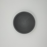 Flat design key and coin bowl in white, close-up view showing geometric silhouette