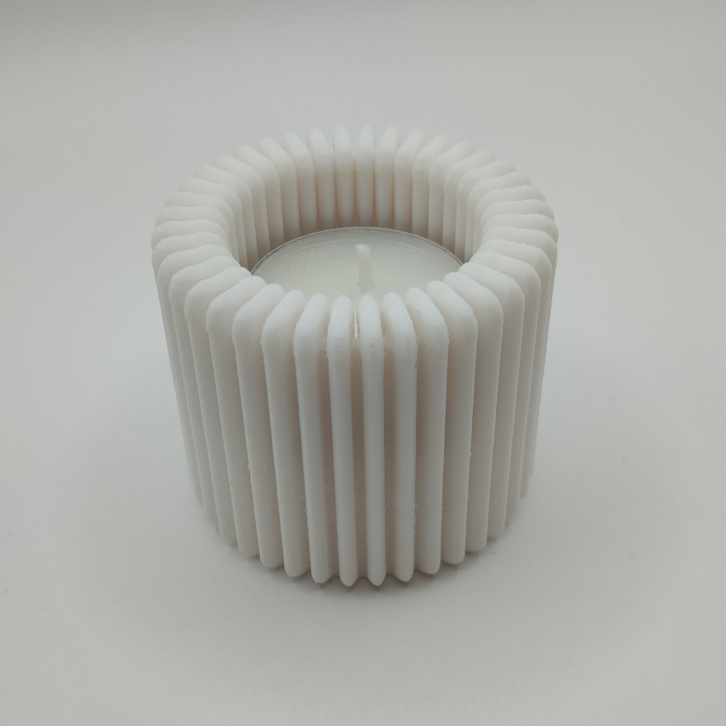 Detail of ribbed surface pattern creating light and shadow on holder