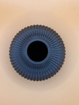 Detail view of ribbed vase surface catching light