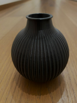 Close-up of ribbed vase showing vertical line texture on rounded form