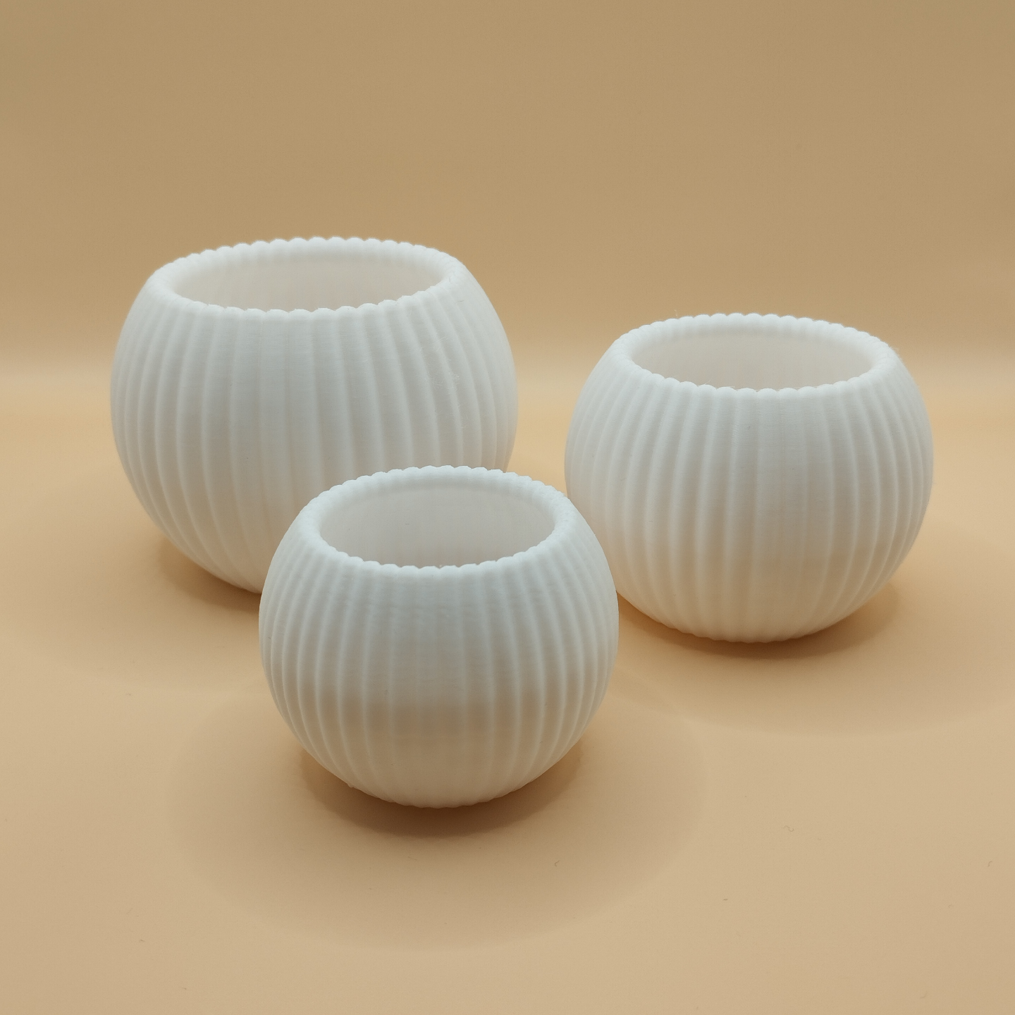 Ribbed texture on round tealight holder catching soft shadow