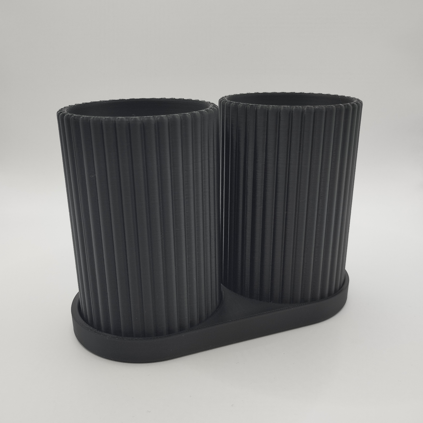 Toothbrush holder set positioned on bathroom counter next to sink