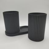 Ribbed pattern detail on toothbrush holder cups catching natural light