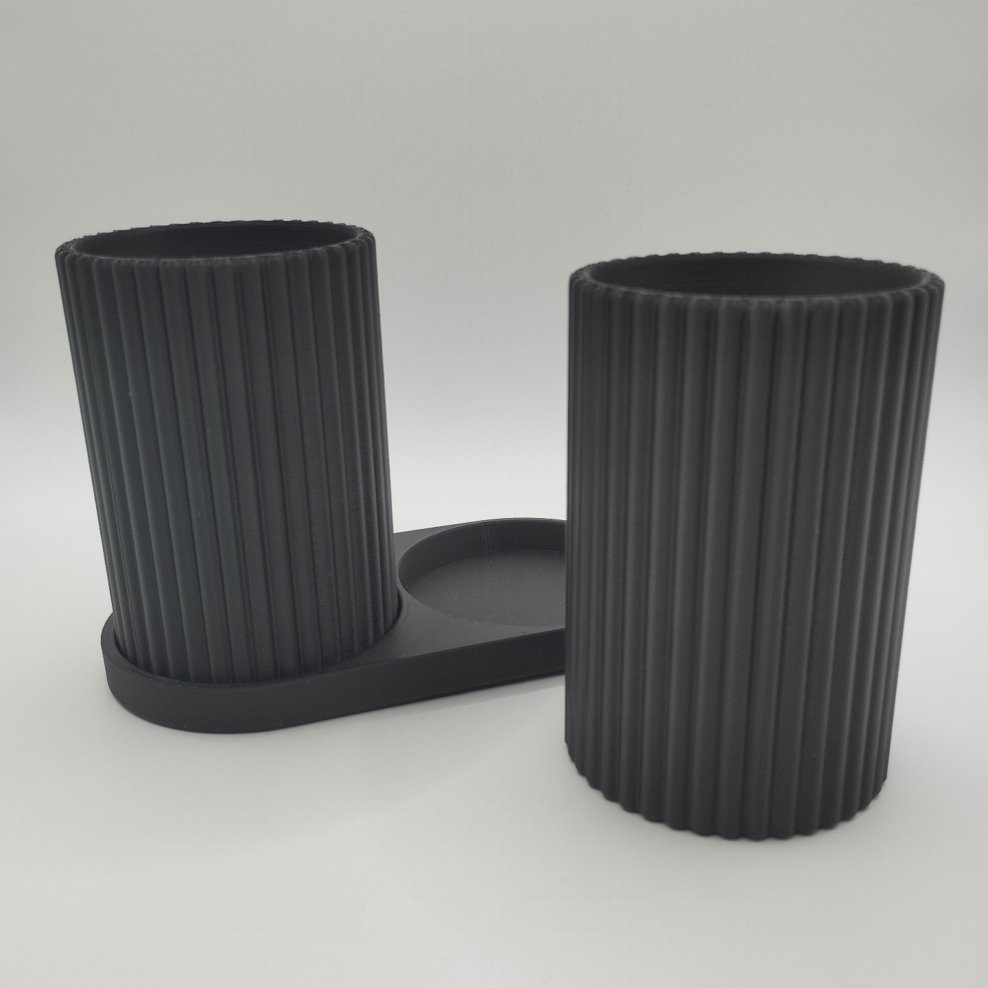Ribbed pattern detail on toothbrush holder cups catching natural light