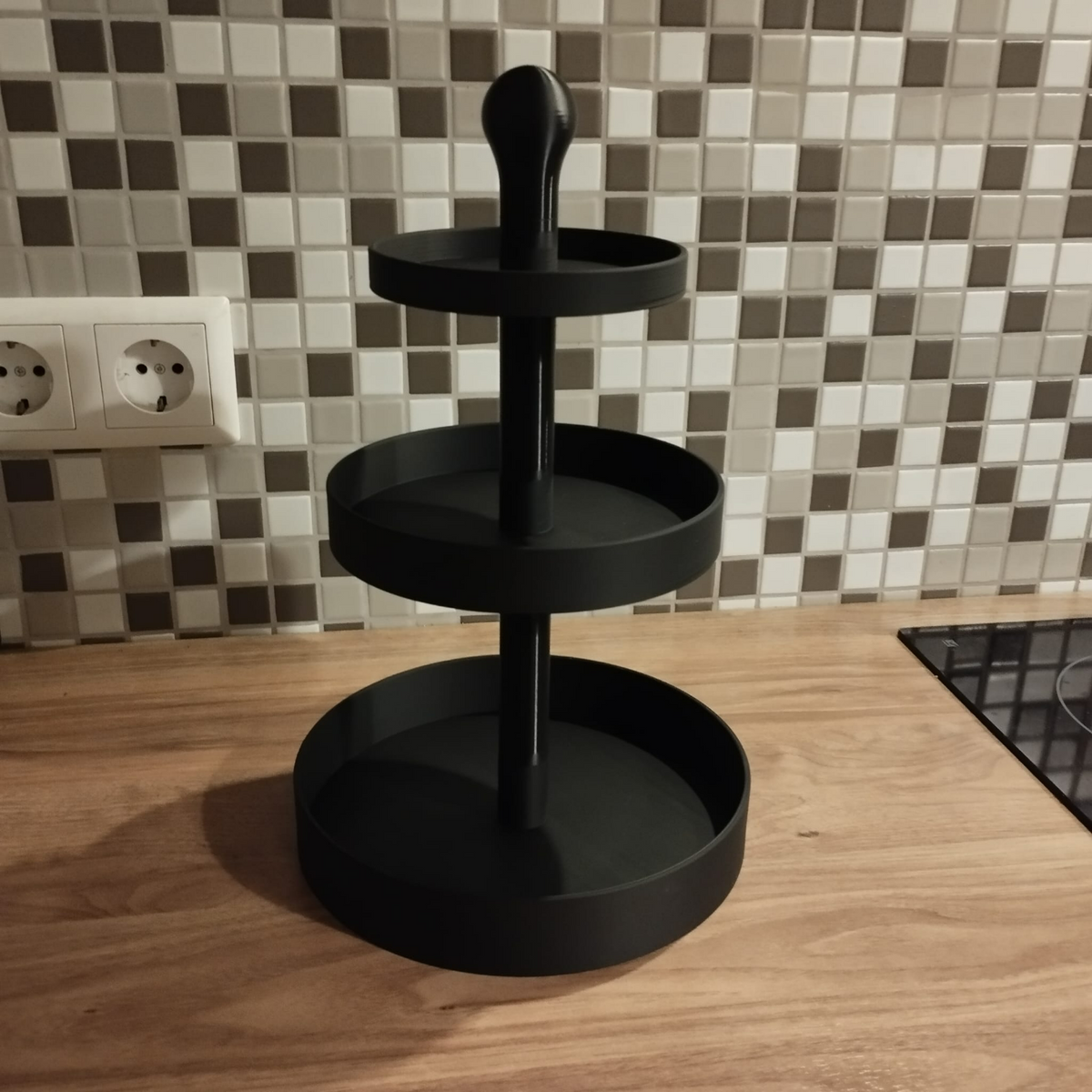 Close-up of three-tier cake stand showing geometric proportions and clean lines