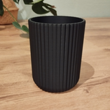 Ribbed utensil holder with vertical texture detail, close-up view