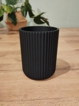 Ribbed utensil holder with vertical texture detail, close-up view
