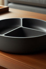 Minimalist snack tray with three compartments, close-up view of clean white surface