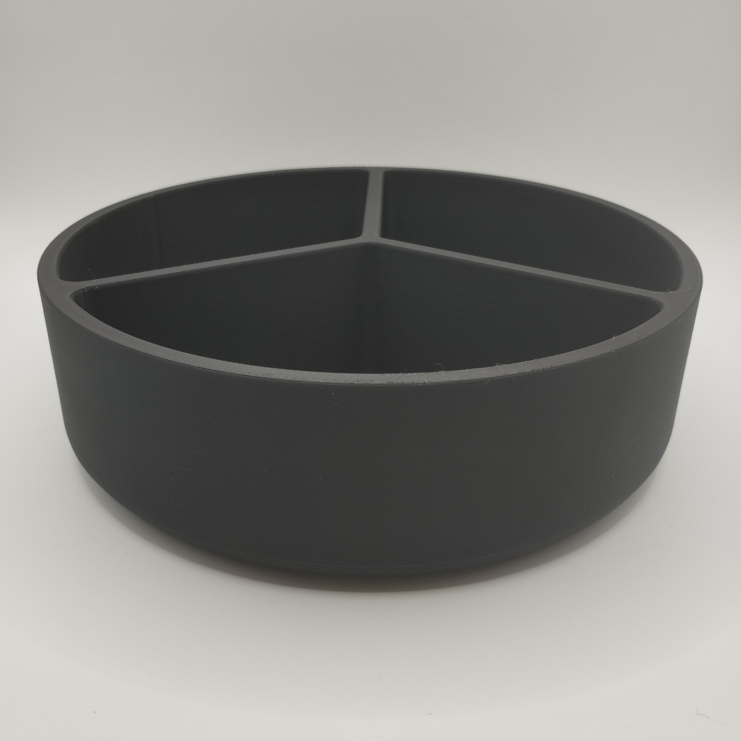 Minimalist snack tray styled on a wooden table with scattered nuts and dried fruit