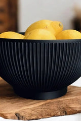 Close-up of ribbed bowl showing vertical texture and pedestal base