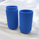 Assembled ribbed toothbrush case displayed on white bathroom shelf