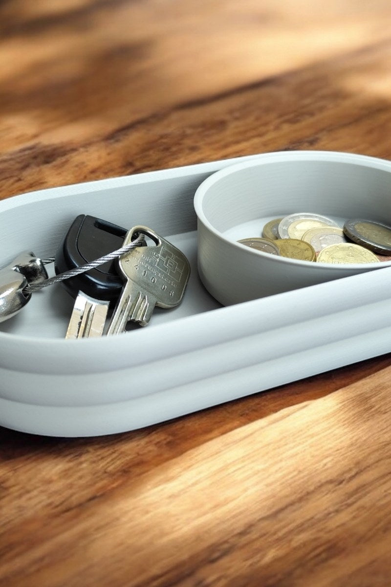 Mid-century tray with horizontal ribbed texture and sliding coin bowl, close-up view