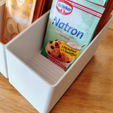Angled baking ingredients organizer holding ingredient bags on kitchen shelf