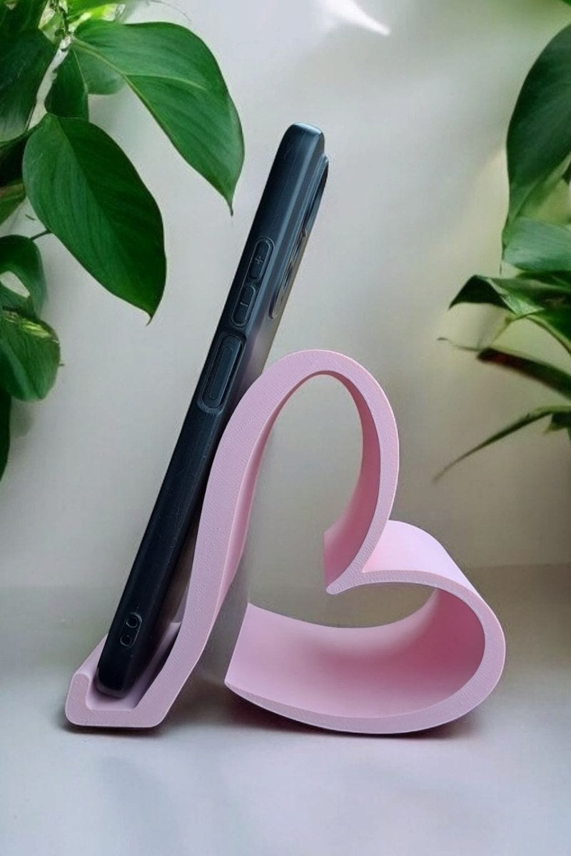 Close-up of Valentine smartphone holder in soft pink, showing heart-shaped form