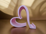 Valentine phone holder placed on a desk beside a smartphone and notebook