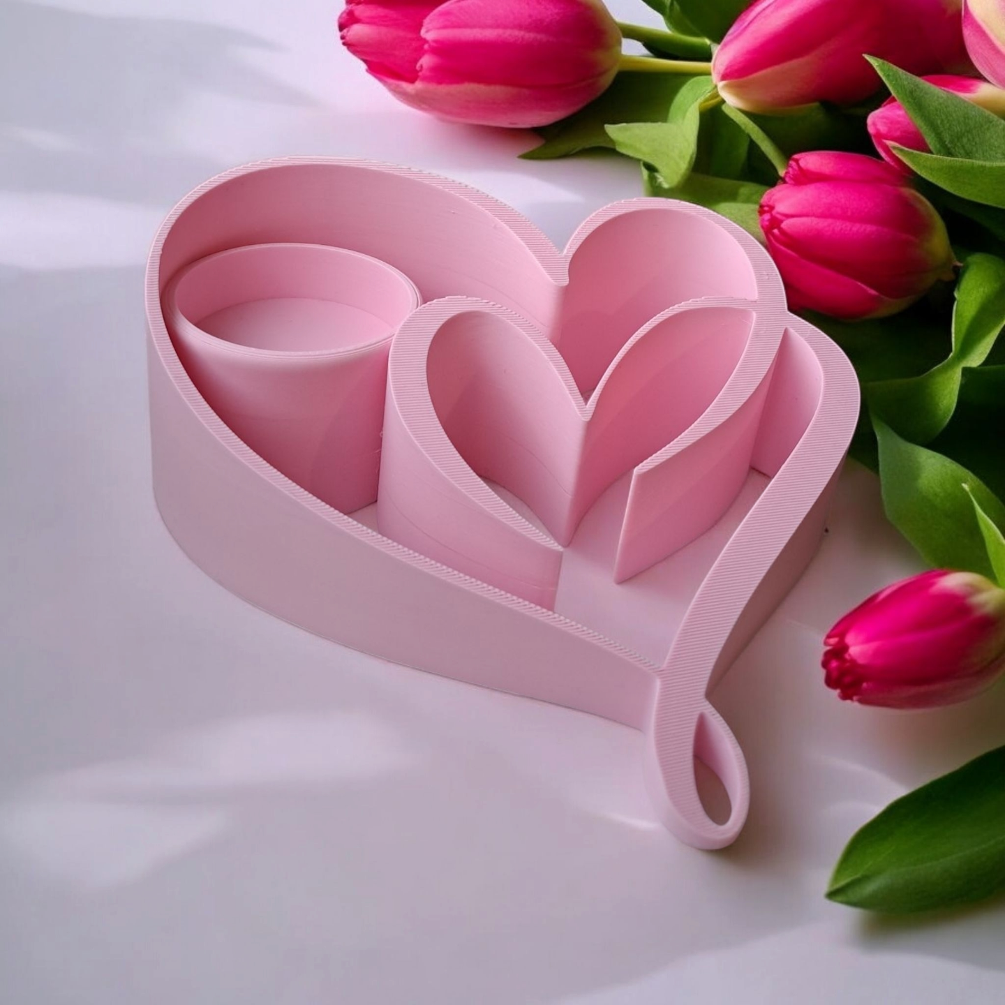 Two hearts tealight holder styled on a shelf with a lit tea light casting warm glow