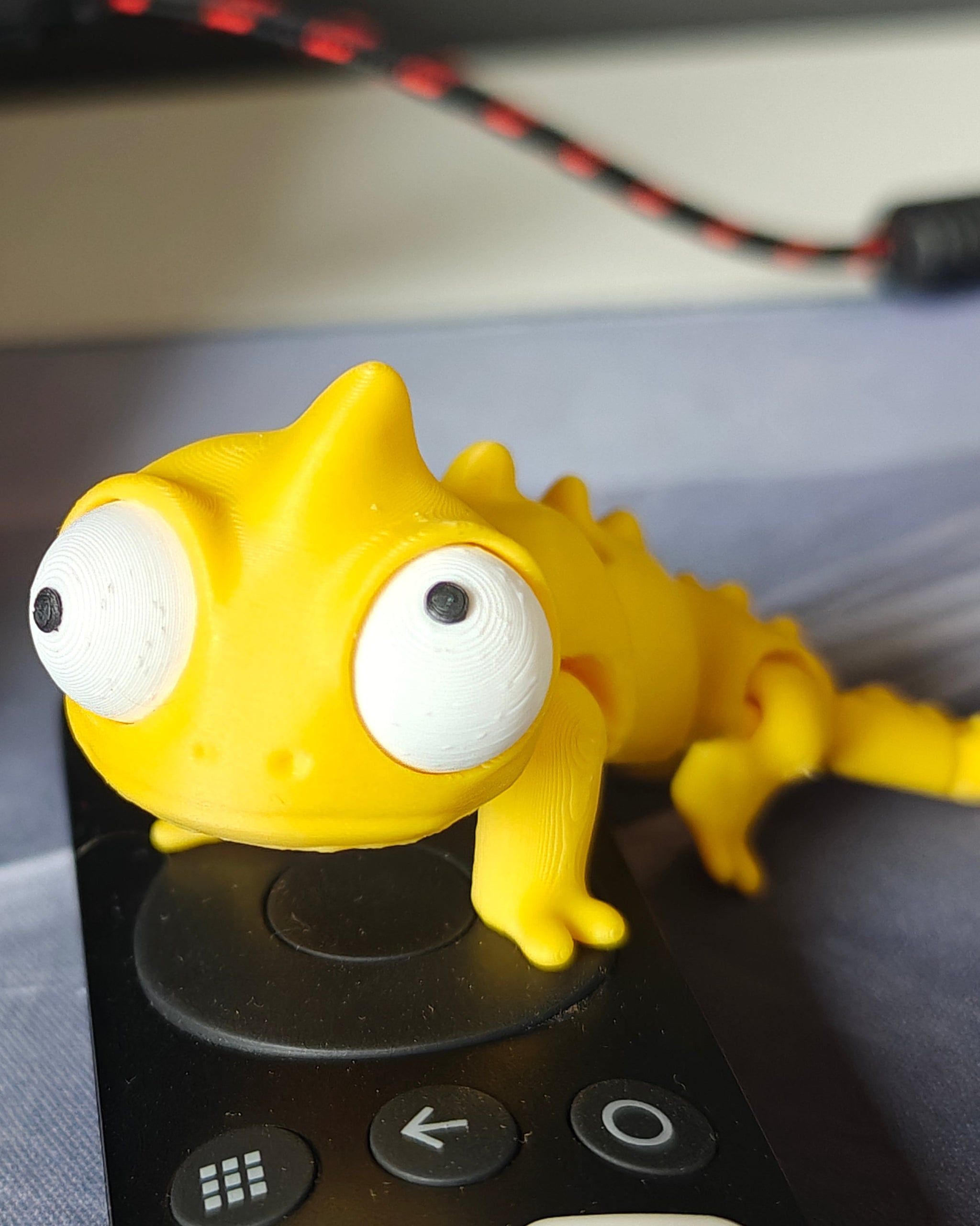 Flexi chameleon figure with large movable googly eyes on a white background
