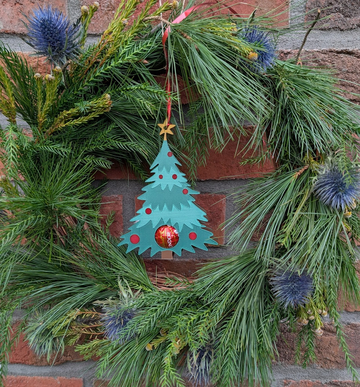Weihnachtsbaumanhänger, der eine Schokokugel versteckt